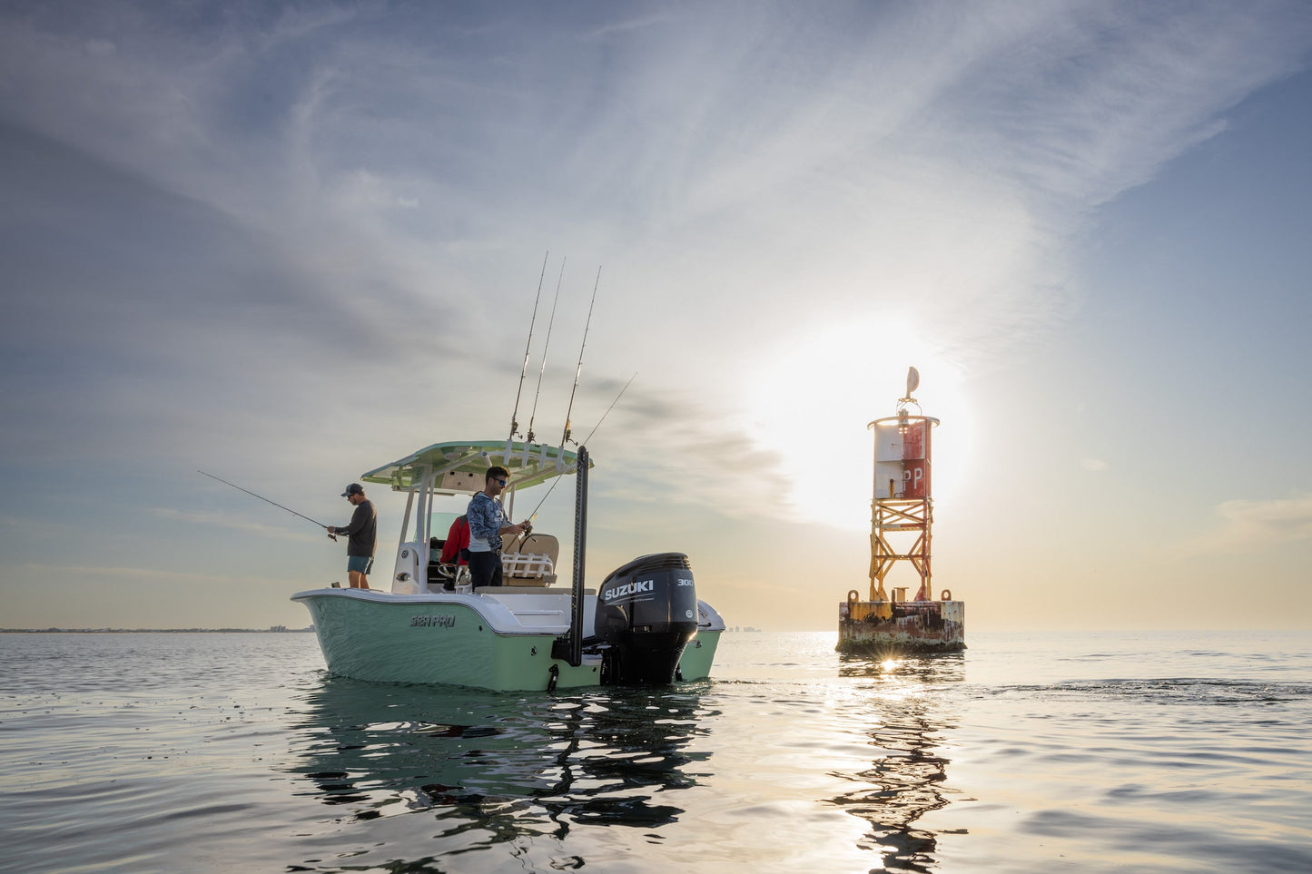 Boat with Suzuki 300 Outboards on the water with a lighthouse in the background